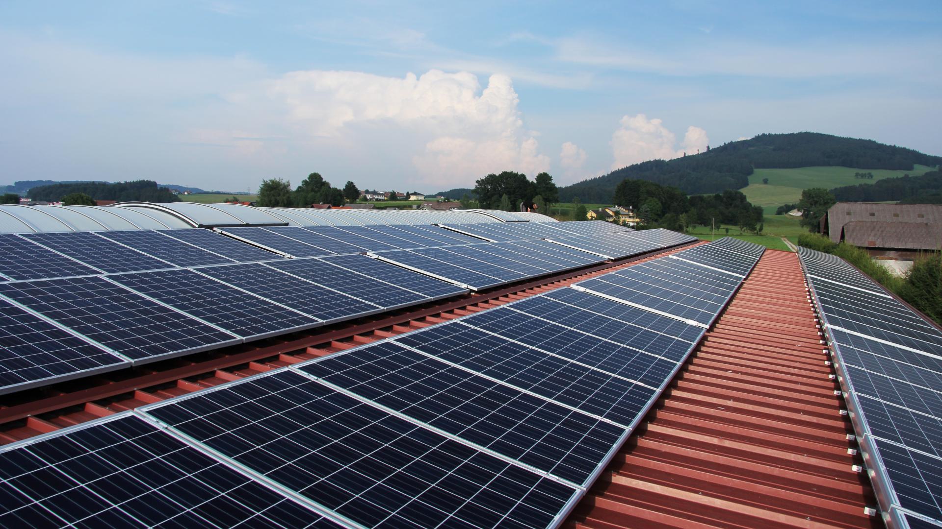 Foto van enkele zonnepanelen op het dak van een loods.